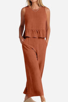 Women's rust-colored sleeveless linen-like feel set with peplum top and wide-leg pants