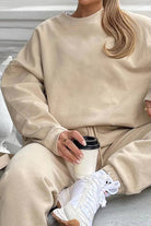 Beige Classic Comfort Athleisure set with relaxed fit sweatshirt and matching pants paired with white sneakers and coffee cup