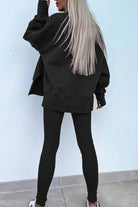 Woman wearing black TimelessChic ultra comfortable two-piece set with oversized sweatshirt and fitted leggings seen from back