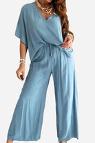 Blue two-piece pantsuit with V-neck top and wide-leg pants for women