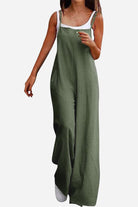 Woman wearing olive green cotton blend comfort wide-leg jumpsuit with white tank top underneath