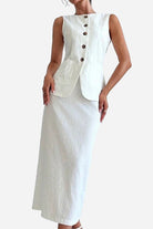 Woman wearing white cotton-linen blend sleeveless vest and high-waisted skirt two-piece outfit