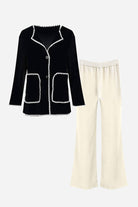 Black contrast-trim knit cardigan with white stitching paired with cream knit pants set