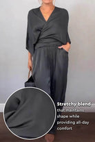 Black Satin Wrap Lounge two-piece set with V-neck top and relaxed pants in stretchy satin fabric.