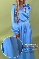 Elegant blue satin two-piece set with statement shoulder blouse and flowing palazzo pants