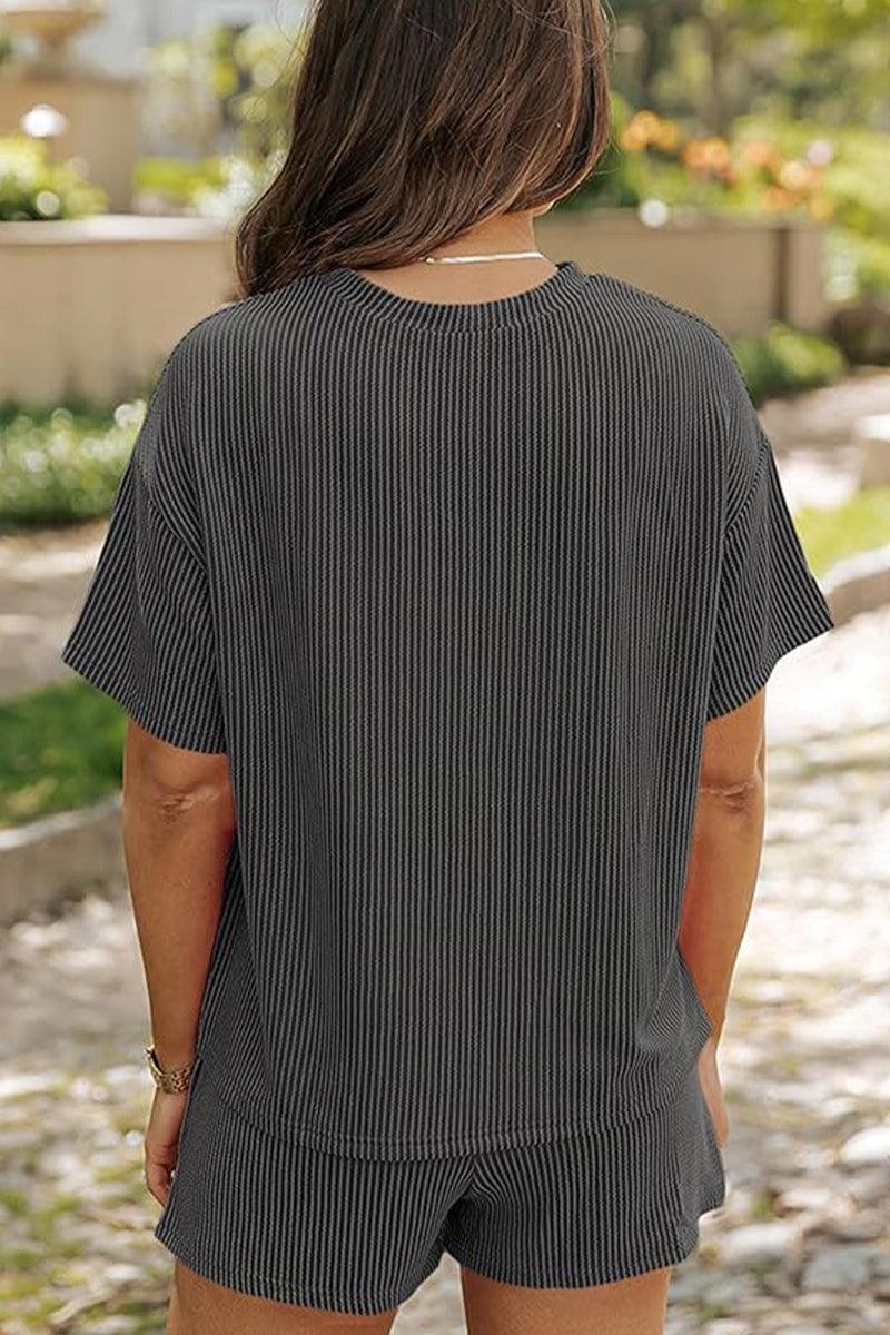 Woman wearing a black striped relaxed-fit top and shorts set for slow mornings outdoors
