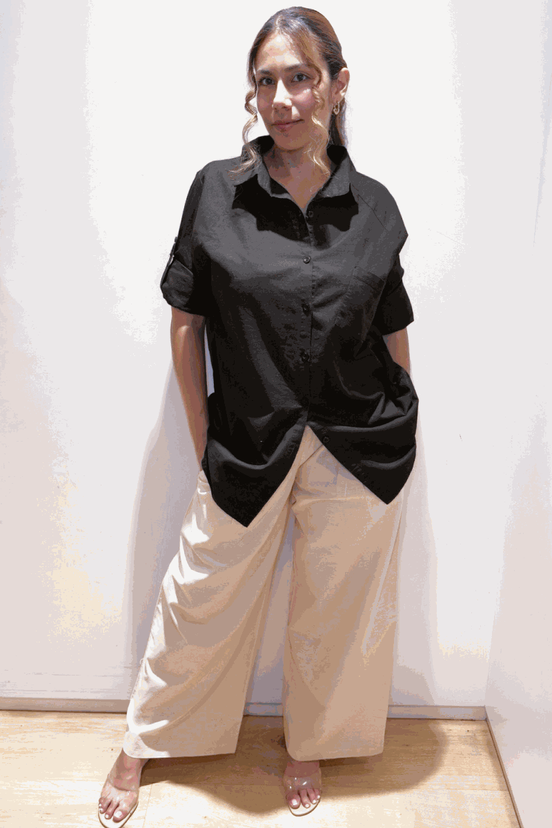 woman wearing oversized linen leaved-in set with black linen-blend shirt and beige flowy palazzo pants