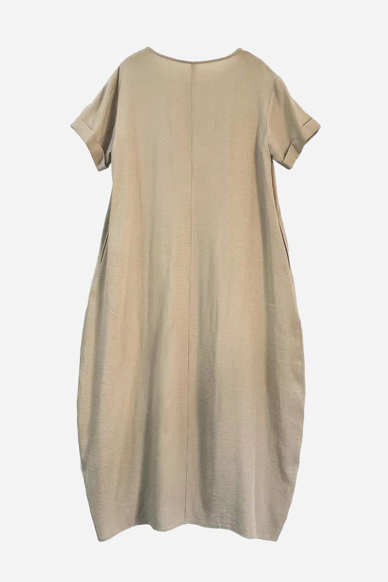 Breeze Cocoon Dress in beige with rolled sleeves, relaxed cocoon shape, and deep side pockets.