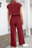 Back view of woman wearing maroon two-piece set with big functional pockets and wide-leg pants outdoors