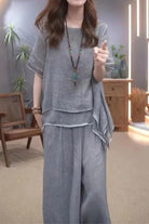 Woman wearing gray Provence cotton linen blend layered top and wide-leg trousers set
