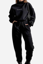Black Storm Sweater Mock Neck athleisure set with relaxed fit and adjustable waist worn by a woman