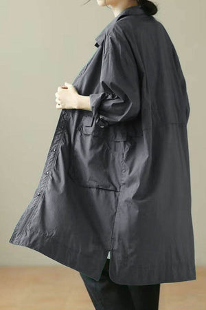 Nomad Ease Oversized Shirt-Jacket in charcoal gray with roll-up sleeves and large front pockets, shown on a model from the back.