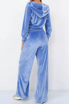 Blue velour tracksuit with cropped hoodie and high-waist pants, soft plush texture, modern fit