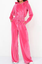 Women's bright pink velour tracksuit with cropped hoodie and high-waist pants