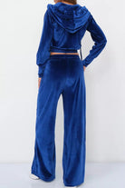 Blue velour tracksuit set with cropped hoodie and high-waist pants in plush polyester fabric
