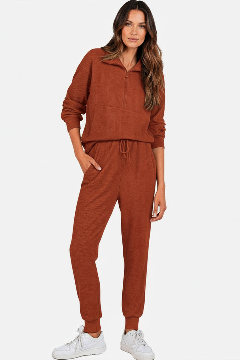 Unisex half-zip pullover and sweatpants set in rust color for casual comfort and style