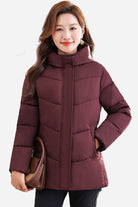 Woman wearing maroon Everyday Warmth mid-length hooded coat with quilted 5-layer thermal insulation and side pockets
