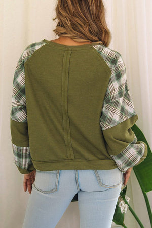 Back view of green waffle knit sweatshirt with green and white plaid brushed sleeves and relaxed fit on woman wearing light blue jeans