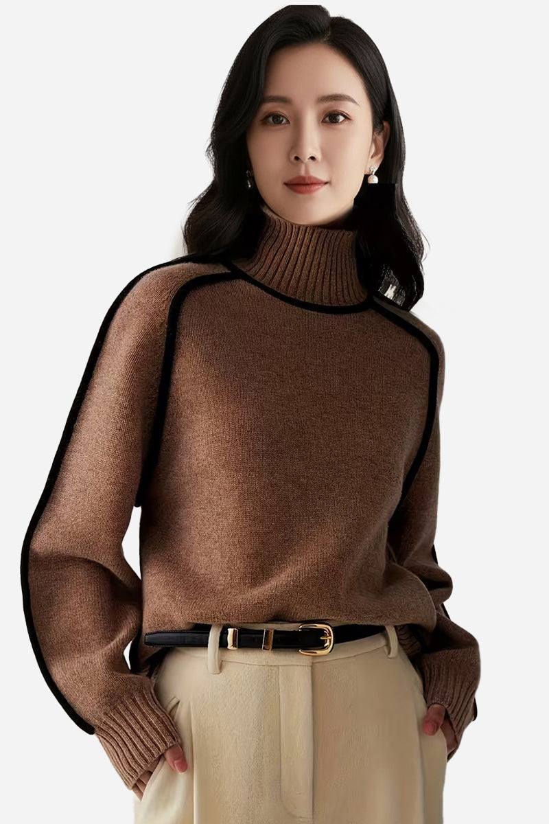 Woman wearing a brown Zero Itch Turtleneck Sweater with black contrast trim and beige pants