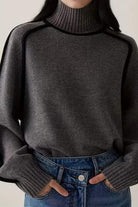 Dark gray Zero Itch Turtleneck Sweater with slimming contrast trim and relaxed fit worn with jeans
