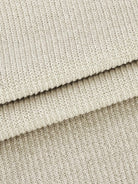 Close-up of soft beige waffle-knit two-piece fabric texture with ribbed pattern