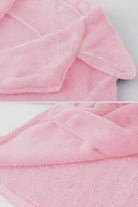 Soft pink open front oversized faux fur jacket with plush texture and draped shawl collar