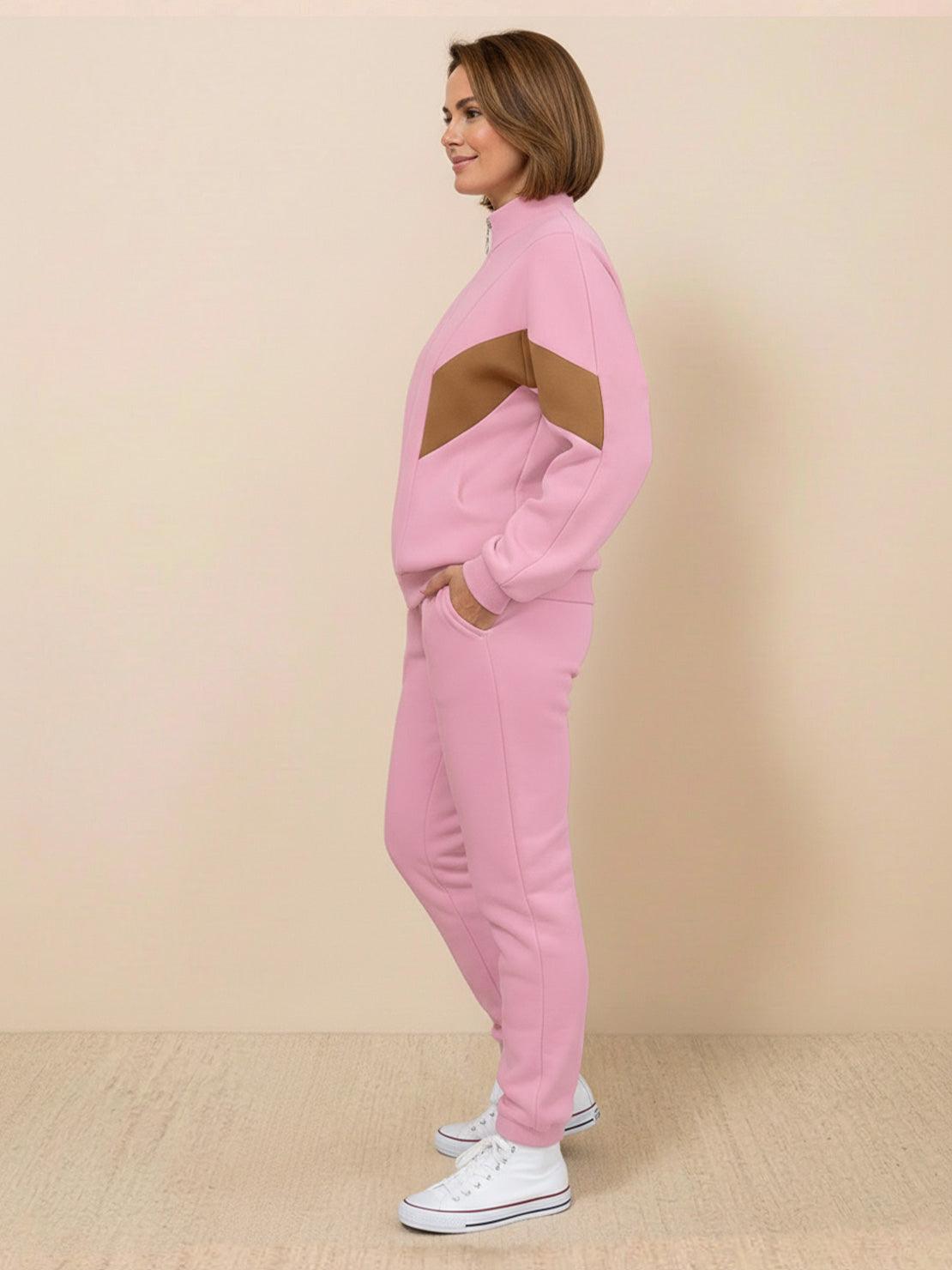 Woman wearing a colorblock comfort tracksuit with contrast curved panels and a stand collar jacket