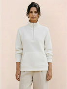 Half-Zip waffle pullover in neutral tone with kangaroo pocket and fold-over collar, cozy textured knit perfect for casual wear