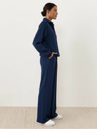 Wrinkle-free two-piece casual polo set with quarter-button top and high-waisted pants in breathable fabric