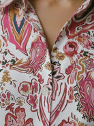 Floral button-down shirt with long roll-up sleeves and hip-length relaxed fit