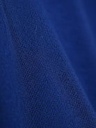 Woman wearing open-front three-piece co-ord with longline cardigan, tank top, and wide-leg trousers