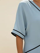 Knot-waist maxi dress with twist-knot detail, V-neckline, batwing sleeves, flowing skirt, and side pockets