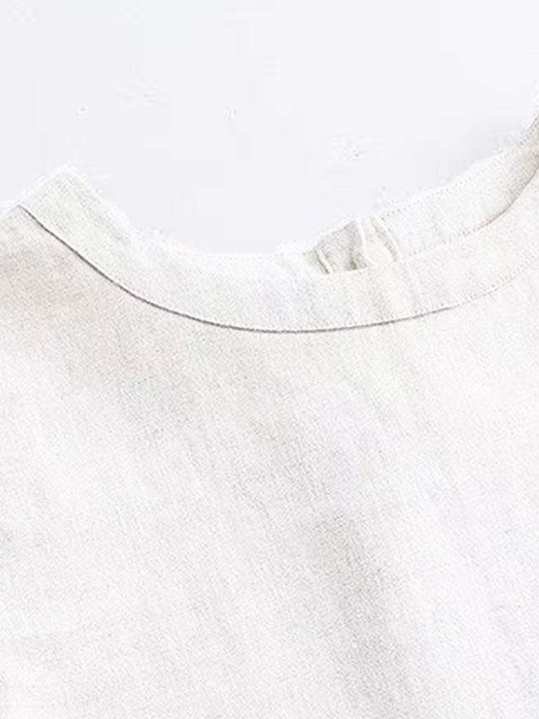 100% cotton-linen sleeveless top with round neckline and button closure at back neck