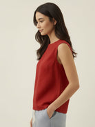 cotton-linen sleeveless top with round neckline and button closure at back, relaxed A-line silhouette, hip-length design