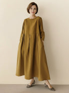 Cotton-linen empire waist dress with natural crinkle texture and A-line maxi silhouette