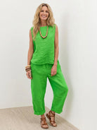 Lightweight 100% cotton crinkle sleeveless co-ord set with relaxed sleeveless top and straight-leg pants.