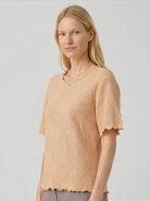 White floral jacquard pleated top with flutter sleeves and lettuce-edge trim