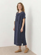 100% linen pocket midi dress with relaxed fit, short sleeves, and small side slits for comfort and ease of movement