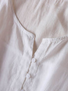 Rusty orange cotton linen dress with embroidered smocked waist and asymmetric midi skirt