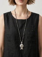 Lightweight 100% cotton linen sleeveless top with relaxed fit, curved hem, chest pocket, and side slits for comfort