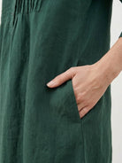 Relaxed cotton linen dress with pintuck pleats, V-neckline, 3/4 sleeves, side slits, and pockets for breathable all-day comfort