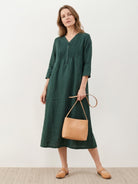 Relaxed A-line 100% cotton linen dress with pintuck pleats, 3/4 sleeves, side slits, and pockets for breathable all-day comfort