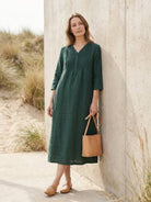 Relaxed A-line cotton linen dress with pintuck pleats, 3/4 sleeves, side slits, and breathable fabric.