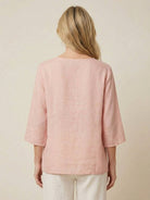 100% cotton linen hand-embroidered shirt with 3/4 flared sleeves and asymmetric hem featuring detailed botanical embroidery