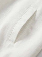 Beige linen-lyocell zip bomber jacket with ribbed waistband and buttoned chest pocket on white background