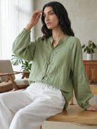 Oversized linen-cotton blouse with batwing sleeves and curved hem in sage green