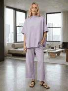 Woman wearing chocolate brown cotton-blend capelet lounge set with batwing sleeves and wide-leg pants