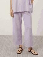 Woman wearing cotton-blend capelet top with wide-leg pants lounge set in blush pink