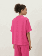 Woman wearing a cotton-blend capelet lounge set with batwing sleeves and wide-leg pants in chocolate brown