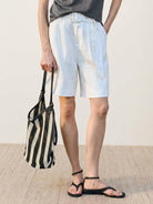 White 100% linen belted shorts with high-rise waist and relaxed wide-leg fit